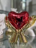 Cuore mani rosso e oro